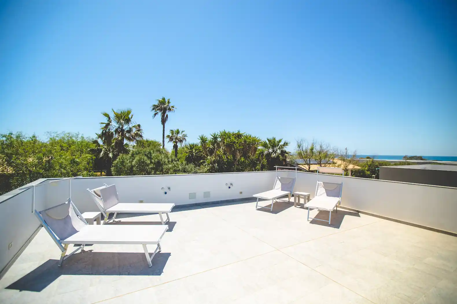 Terrazzo sulla casetta Glamping in Sicilia con vista mare e 4 sdraio.